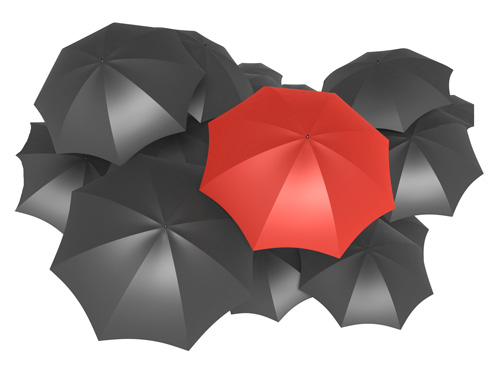 Open red umbrella surrounded by open black umbrellas